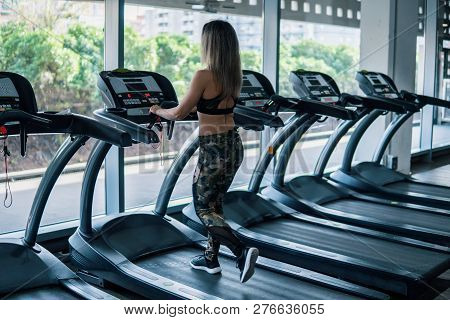 Young Fit Woman Doing Running Exercise In Gym