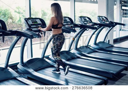 Young Fit Woman Doing Running Exercise In Gym