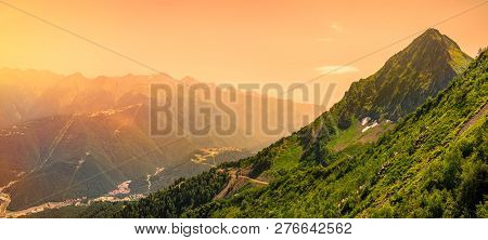 Bright Sunrise In The Mountains. Panoramic View Of The Valley With Residential Buildings, Surrounded