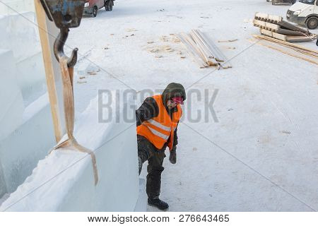 Slinger In An Orange Helmet At The Installation Site