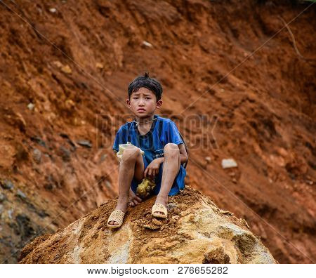 Sa Pa, Vietnam - May 31, 2016. A Boy Sitting On Rock In Sa Pa, Vietnam. Sa Pa Is A Mountain Town In 