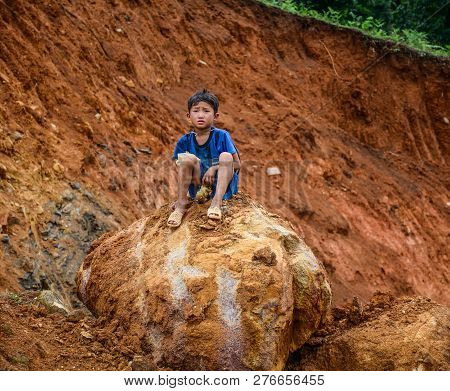 Sa Pa, Vietnam - May 31, 2016. A Boy Sitting On Rock In Sa Pa, Vietnam. Sa Pa Is A Mountain Town In 