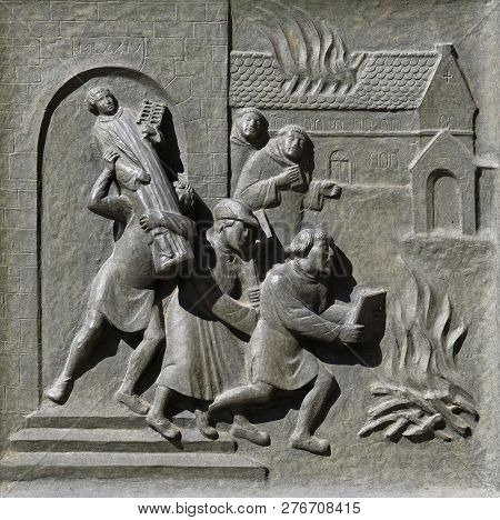 ZURICH, SWITZERLAND - JUNE 23, 2018: Ittingen Monastery in Frauenfeld is stormed and set on fire in July 1524., relief on the door of the Grossmunster (