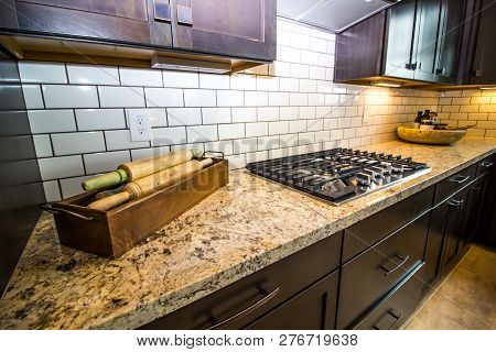 Granite Kitchen Counter With Box Of Large Rolling Pins
