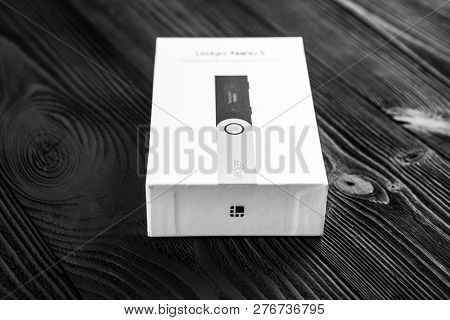 UKRAINE, ROVNO - ON DECEMBER 2: Ledger hardware wallet for cryptocurrency on a wood background