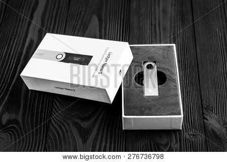 UKRAINE, ROVNO - ON DECEMBER 2: Ledger hardware wallet for cryptocurrency on a wood background