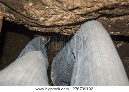 Shimmying Through A Tiny Crevasse In A Cave
