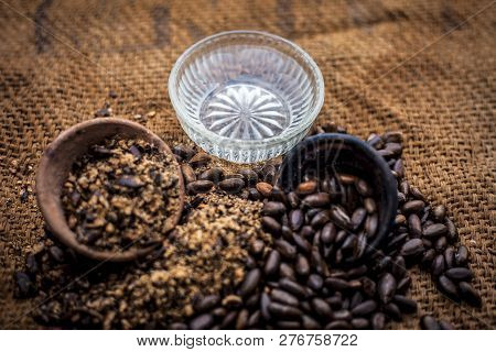 Home Remedy To Cure Lice Or Joon On Brown Colored Surface I.e. Custard Apple Seeds Dried And Powdere