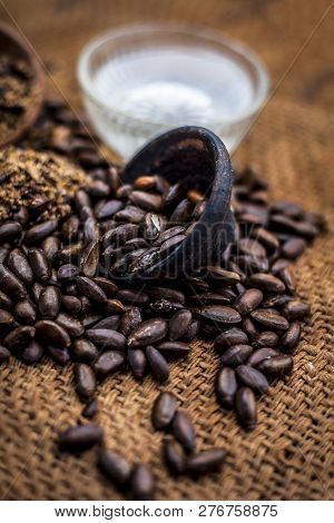 Home Remedy To Cure Lice Or Joon On Brown Colored Surface I.e. Custard Apple Seeds Dried And Powdere