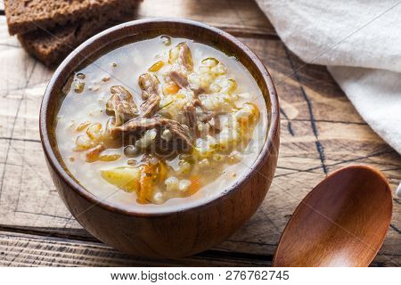 Kharcho Soup With Meat And Rice On Wooden Table