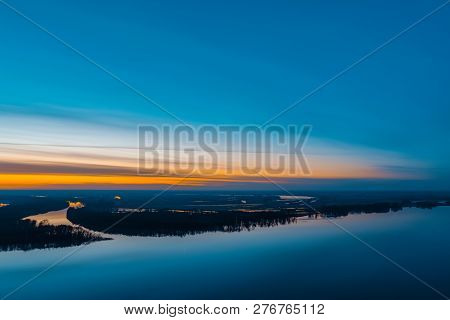 Beautiful River With Big Island With Trees Under Predawn Sky. Bright Orange Stripe In Picturesque Cl