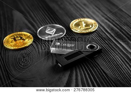 UKRAINE, ROVNO - ON DECEMBER 2: Ledger hardware wallet for cryptocurrency on a wood background