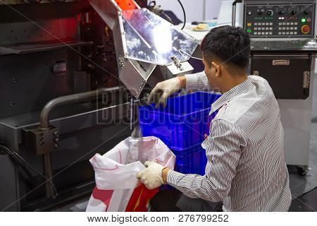 Worker Collect Spring Products In Busket From Spring Coiling Machine