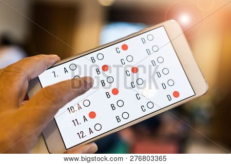 Student Testing E-learning Exam On Tablet Computer With Multiple Choice Questions By Finger Clicking