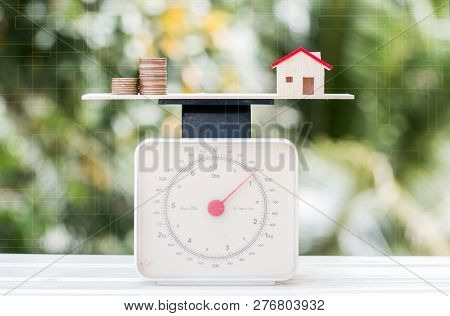 Home Loan And Cost Of Living For Investment Real Estate Concept : House Money Coins On Weighing Scal