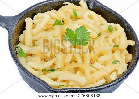 Close Up Of Pan With Spatzle With Butter And Parsley On White Background