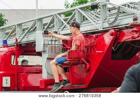 Horki, Belarus - July 25, 2018: A Boy Takes A Selfie On A Red Car Rescue Service 112 On A Holiday In