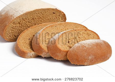 Loaf Of Fresh Bread Partially Sliced On White Background