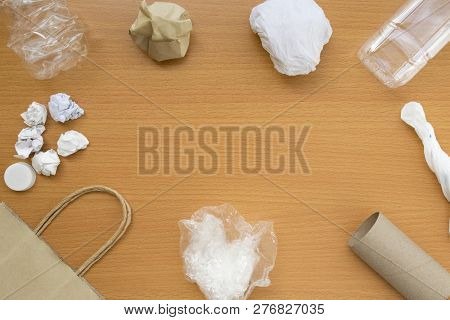 Top View Of Recycling Garbage Waste On Wooden Background With Center Copy Space , Eco And Save World