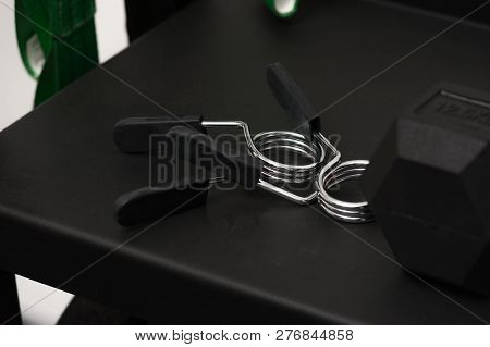 Two Rubber Handles Hand Trainer On Black Table, Dark Background. Muscle Trainer Expander For Adults,