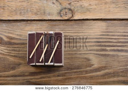 A Burnt Match And Two Whole Matches On Matchboxes
