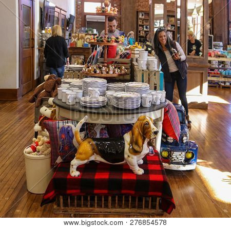 Basset Hound Statue In Front Of A Table Of China With Customers In The Background In The Pioneer Wom