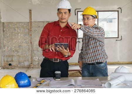 Team Of Architects People In Group On Construciton Site Check Documents And Business Workflow
