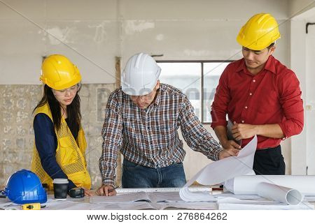 Team Of Business People In Group, Architect And Engeneer On Construciton Site Check Documents And Bu