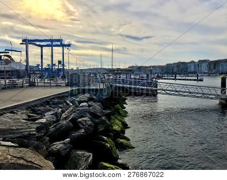 View Of The Harbour From Over Some Rocks On Galicia Spain