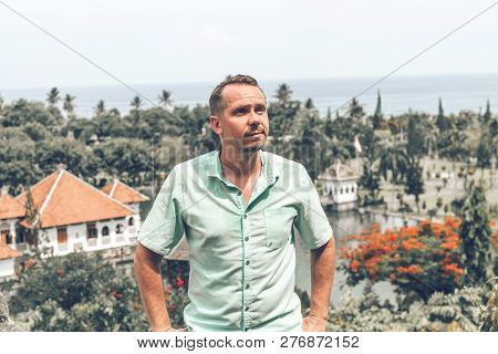 Young Man In Taman Ujung Water Palace, Bali Island, Indonesia.