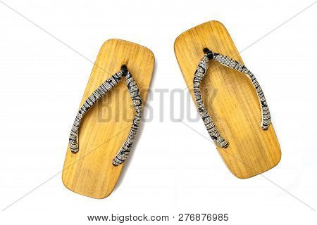 Close Up Old Used Wooden Japanese Sandal Isolated On White Background. It Is A Form Of Traditional J