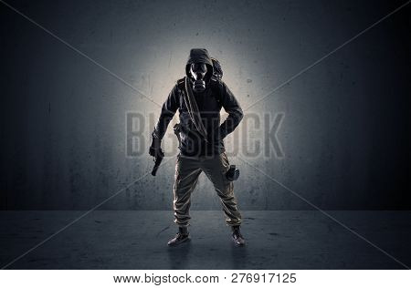 Bad agent in a dark room with arms on his hand and gas mask