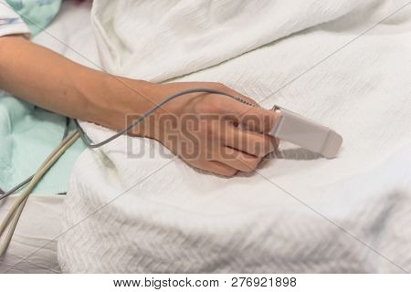 Woman Hand With Pulse Oximeter And Heart Rate Fingertip Equipmen