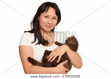 Young Girl In A White T-shirt Holds A Cat