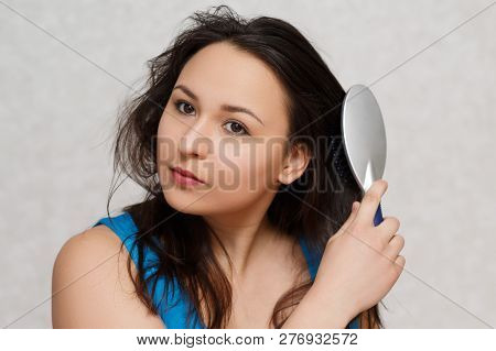 A Pretty Young Girl Brushing Her Teeth