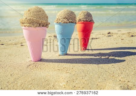 Colorful Sand Cones In The Sand On The Beach,summer Concept,used Split Toning For Vintage Style.