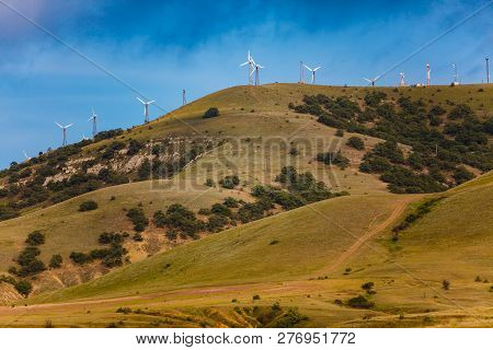 Wind Turbines Producing Enegry. Electricity Supply In Mountain Area