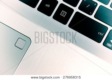 Close Up Of The Laptop Keyboard And Touchpad. Black Keys On A Light Background. Silver Scratched Tex