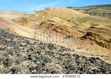 Colored sands in the Makhtesh Gadol erosion crater in the desert in Israel