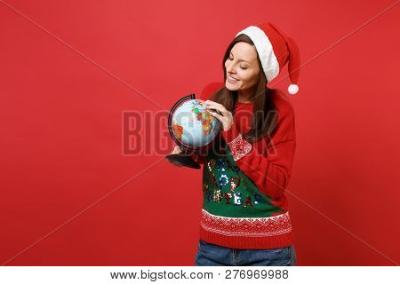 Stunning Young Santa Girl In Knitted Sweater Christmas Hat Looking On World Globe In Hands Isolated 