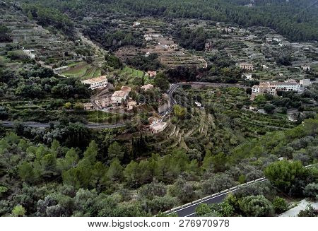Aerial Drone View Of Small Hillside Banyalbufar Town On West Coast Of Mallorca. Surrounded By Tramun