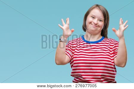 Young adult woman with down syndrome over isolated background smiling crossing fingers with hope and eyes closed. Luck and superstitious concept.