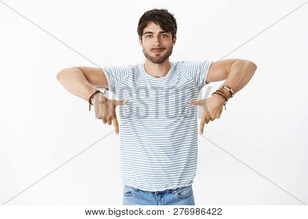 Portrait Of Handsome Charming Young European Male With Big Blue Eyes And Bristle Pointing Down Indic