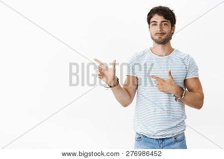 Portrait Of Self-assured Good-looking Tanned Young Caucasian Male With Bristle, Blue Eyes In Striped