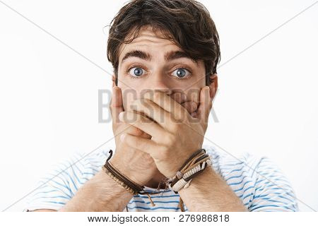 Headshot Of Surprised Stunned Handsome Young Male With Blue Eyes Covering Mouth As Feeling Too Excit