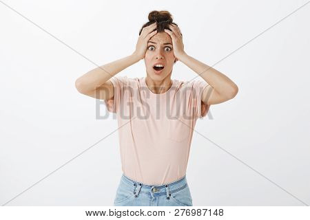 Studio Shot Of Panicking Woman Realising Forgot To Send Important Email Standing Concerned With Hand