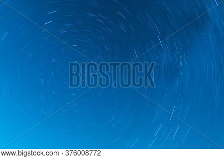 Background Of Round Or Circular Star Track Or Trajectory On The Blue Clear Night Sky. Symbol Of Spac