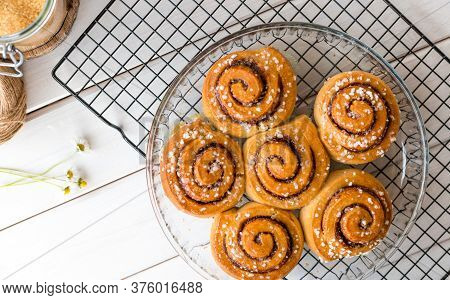 Freshly Baked Cinnamon Buns With On A Wooden Background. Kanelbule - Swedish Dessert. Food Concept. 