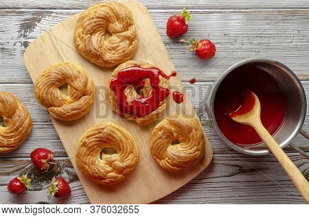 A Homemade Cruller Donuts With Strawberry Jam