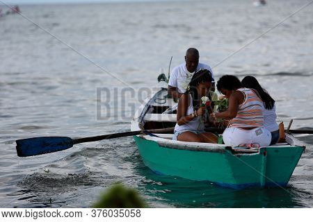 Salvador, Bahia / Brazil - February 2, 2015: Supporters Of Candomble Are Seen On The Rio Vermelho Be